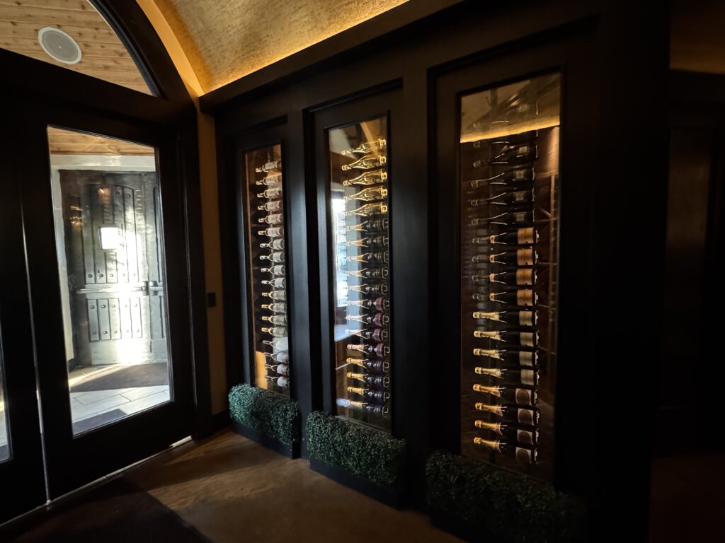 Next Door by Wegmans front door with wine bottles.